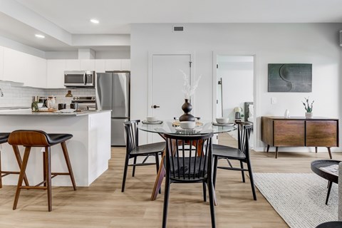 a kitchen and dining room with a table and chairs